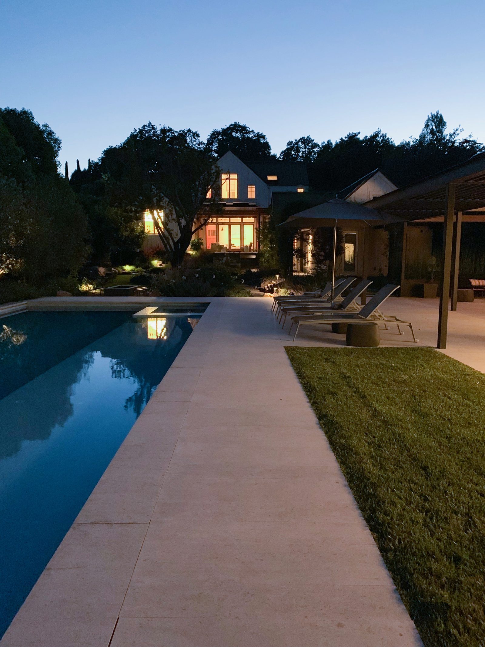 Pool and house illuminated at night
